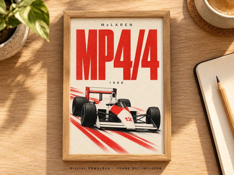 May include: A framed poster featuring a white and red McLaren MP4/4 Formula 1 race car with the number 12. The text reads McLaren, MP4/4, and 1988. The design includes red motion lines on a white background, presented in a light wood frame.