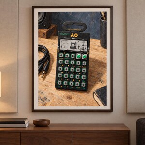 May include: A black Teenage Engineering PO-12 Rhythm pocket operator drum machine and sequencer. The device features a monochrome LCD screen with a sewing machine icon, sixteen numbered buttons, two green rotary knobs, and the text rhythm.