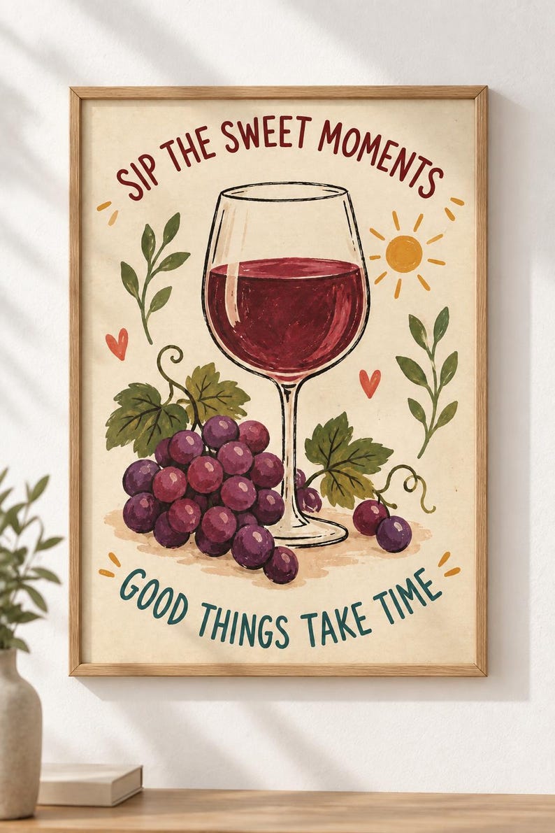 May include: A framed wall art print featuring a glass of red wine, a cluster of purple grapes, green leaves, a yellow sun, and small red hearts. The text reads SIP THE SWEET MOMENTS at the top and GOOD THINGS TAKE TIME at the bottom in dark lettering.