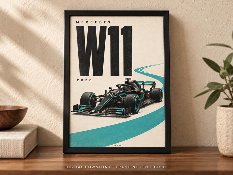 May include: A framed poster featuring a black Mercedes W11 Formula 1 race car with teal accents on a light background. The text reads MERCEDES W11 and 2020 in bold black lettering. A teal curved line represents a track path on the lower portion.