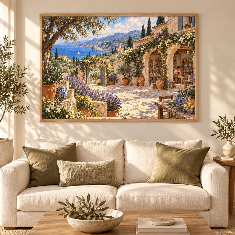 May include: A framed landscape painting depicting a Mediterranean coastal scene with a stone villa, blooming flowers, terracotta pots, and a view of the blue sea. The artwork features warm sunlight, lush greenery, and a person working in an open archway.