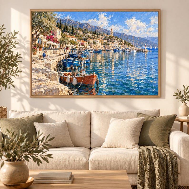 May include: A framed landscape painting depicting a Mediterranean coastal village with stone buildings, a harbor filled with blue and orange fishing boats, and a bright blue sky with white clouds, all rendered in a textured, impressionistic style.