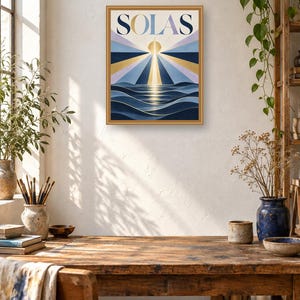 May include: A rectangular framed wall art print featuring the word SOLAS in bold capital letters at the top. The graphic depicts a stylized sun rising over dark blue ocean waves with radiating beams of light in shades of gold, blue, and lavender.