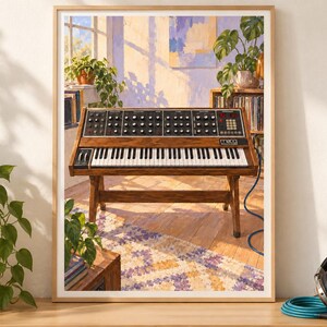 May include: A framed art print depicting a wooden Moog synthesizer on a stand, positioned in a sunlit room with a patterned rug, potted plants, and a bookshelf. The synthesizer features a black control panel with numerous knobs and white keys.