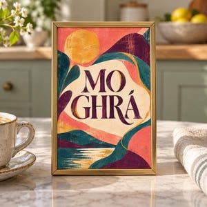 May include: A rectangular gold-framed print featuring an abstract landscape with a yellow sun, rolling hills in shades of pink, purple, and teal, and the text MO GHR&Aacute; centered in dark purple lettering against a cream-colored background.