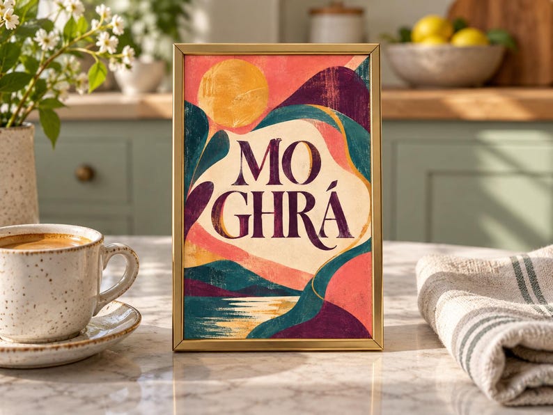 May include: A rectangular gold-framed print featuring an abstract landscape with a yellow sun, rolling hills in shades of pink, purple, and teal, and the text MO GHR&Aacute; centered in dark purple lettering against a cream-colored background.