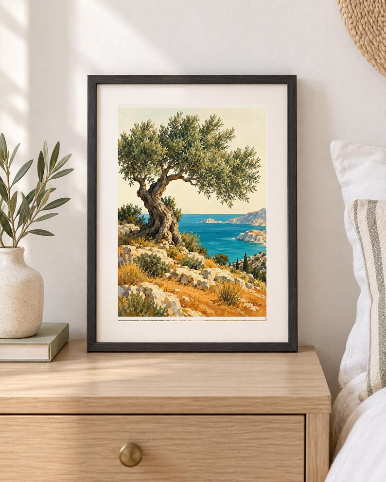 May include: A framed art print featuring a landscape painting of a gnarled olive tree perched on a rocky, golden-hued hillside overlooking a deep blue sea and distant coastline under a clear, pale sky, enclosed in a simple black frame.