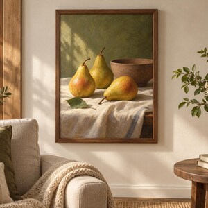 May include: A framed still life painting depicting three yellow and red pears and a brown bowl resting on a white textured cloth. The pears are arranged in the foreground with a single green leaf, set against a muted green background.