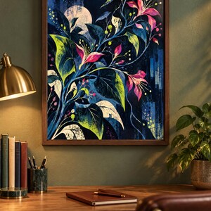 May include: A framed wall art print featuring a dark blue nocturnal scene with a pale moon, vibrant pink flowers, and green foliage. The artwork displays a stylised botanical composition with deep indigo shadows and bright lime green accents.