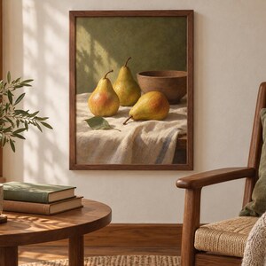 May include: A framed wall art print featuring a still life painting of three yellow and green pears and a brown bowl resting on a textured white cloth. The artwork is enclosed in a simple dark wood frame and displayed on a light-colored wall.