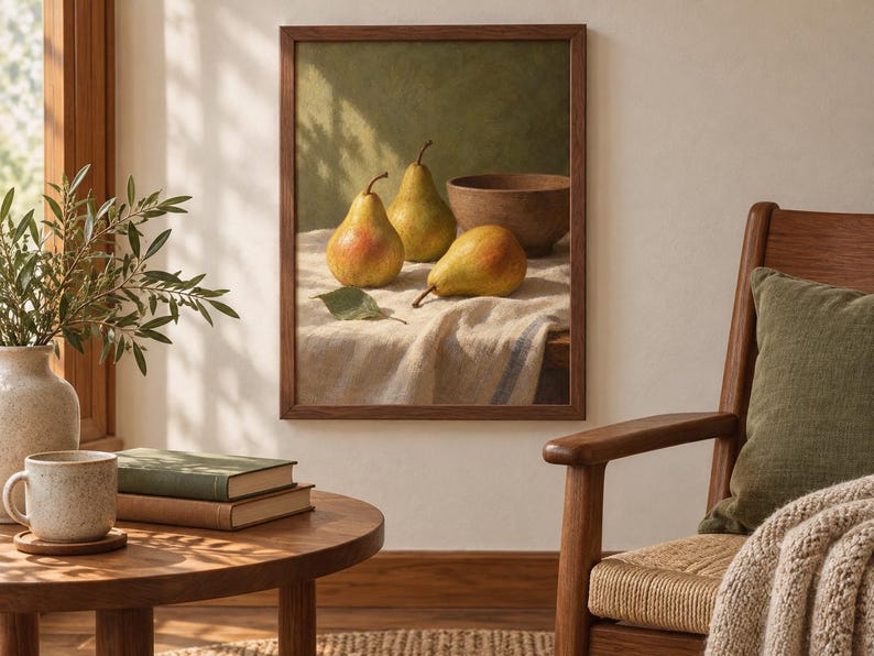 May include: A framed wall art print featuring a still life painting of three yellow and green pears and a brown bowl resting on a textured white cloth. The artwork is enclosed in a simple dark wood frame and displayed on a light-colored wall.