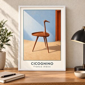 May include: A framed art print featuring a wooden side table with three legs and a neck-like extension resembling a bird, set against a blue and orange background. The text CICOGNINO and Franco Albini is printed in black at the bottom of the white border.