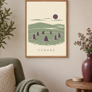 May include: A framed rectangular wall art print featuring a landscape illustration of a stone circle in a green field under a dark purple sun. The scene includes rolling hills and the text TYRONE centered at the bottom in a dark serif font.