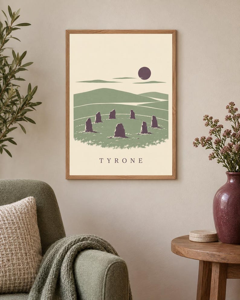 May include: A framed rectangular wall art print featuring a landscape illustration of a stone circle in a green field under a dark purple sun. The scene includes rolling hills and the text TYRONE centered at the bottom in a dark serif font.
