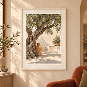 May include: A framed wall art print featuring an ancient olive tree with a gnarled, textured trunk and green leaves. A large, terracotta-coloured ceramic amphora sits at the base of the tree on a stone patio, casting long shadows in the sunlight.