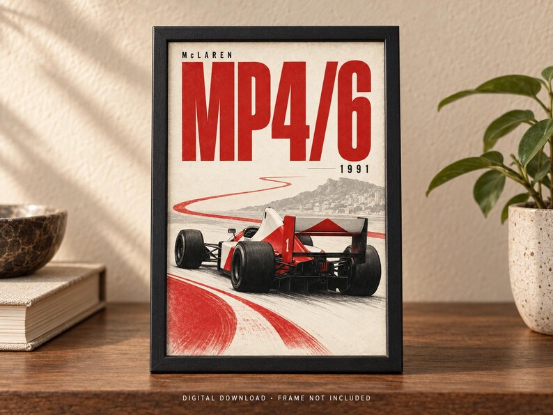 May include: A framed poster featuring a red and white McLaren MP4/6 Formula One race car from 1991 on a track. The text reads McLaren MP4/6 1991. The artwork shows the car from the rear, with a red winding track line leading toward a distant hill.