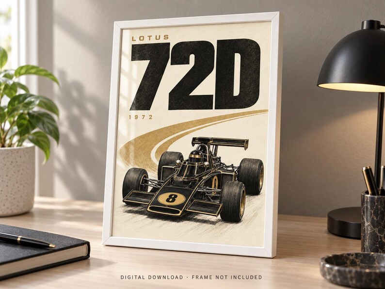 May include: A framed poster featuring a black and gold Lotus 72D Formula One race car with the number 8 on the front. The text LOTUS 72D and 1972 are printed in large black letters at the top. The car is depicted on a beige background with a curved track.