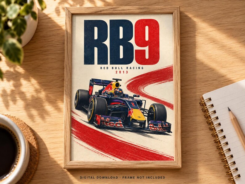 May include: A framed poster featuring a dark blue and red Formula One race car on a track. The text RB9, RED BULL RACING, and 2013 are printed above the car. A red brushstroke graphic curves across the background. The bottom text reads DIGITAL DOWNLOAD.