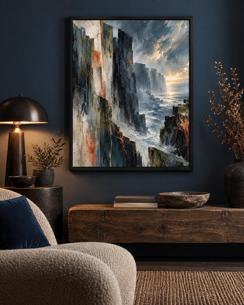 May include: A framed rectangular wall art print featuring an oil painting of dramatic dark cliffs overlooking a turbulent ocean at sunset. The artwork displays deep blues, grays, and earthy orange tones with visible brushstrokes depicting waves.