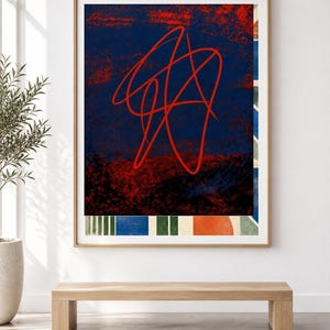 May include: A framed rectangular wall art piece featuring a dark blue background with a prominent red continuous line scribble. The bottom section displays a horizontal border of alternating vertical stripes in blue, green, and white, with a solid orange circle.