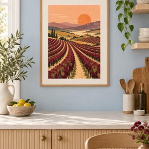 Pu&ograve; includere: Una stampa artistica da parete rettangolare in una cornice di legno chiaro che presenta un'illustrazione paesaggistica di un vigneto con filari di viti rosso scuro, colline e un grande sole arancione che tramonta all'orizzonte.