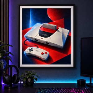 May include: A framed art print featuring a white and red Amstrad GX4000 video game console with a cartridge inserted and a matching controller. The console and controller are set against a vibrant background of geometric red and blue shapes.