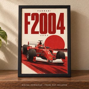 May include: A framed poster featuring a red Ferrari F2004 Formula 1 race car on a track. The text FERRARI and F2004 is printed in large red letters at the top, with a large red circle in the background. The design includes the number 2004.