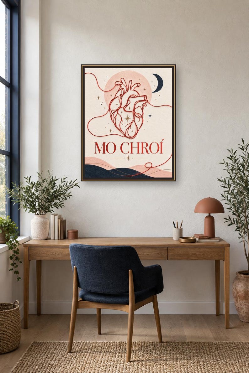 May include: A framed wall art print featuring a red line-art anatomical heart centered against a pale background. The design includes a dark blue crescent moon, small stars, and wavy lines at the bottom. The text MO CHRO&Iacute; is printed in red below the heart.