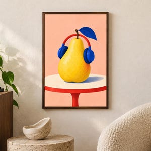 May include: A framed wall art print featuring a bright yellow pear wearing large blue headphones. The pear sits on a round white tabletop with a red base, set against a solid light peach background. A single dark blue leaf extends from the top.