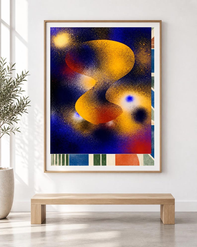 May include: A framed rectangular wall art print featuring a central abstract yellow and orange organic shape against a deep blue spray-painted background. The bottom section displays a series of vertical stripes in green, blue, and orange tones.