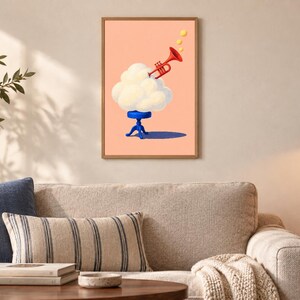 May include: A framed wall art print featuring a surreal illustration of a fluffy white cloud resting on a small blue stool. A bright red trumpet emerges from the top of the cloud, emitting three small yellow circles against a solid peach background.