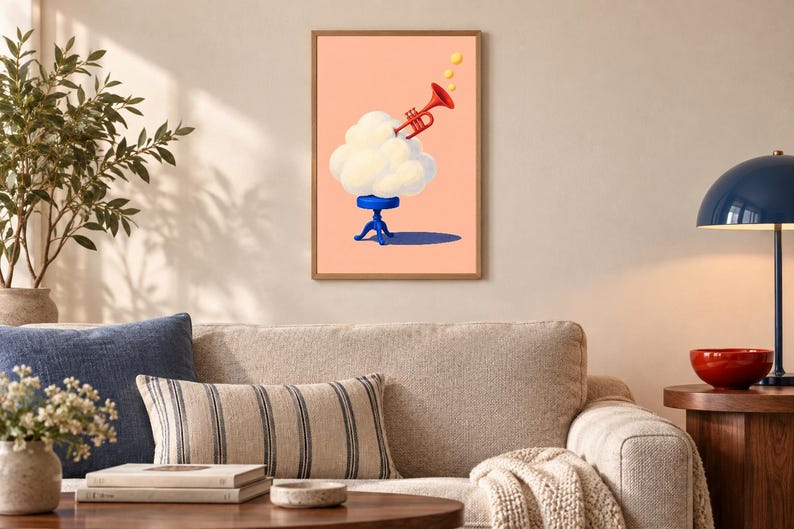 May include: A framed wall art print featuring a surreal illustration of a fluffy white cloud resting on a small blue stool. A bright red trumpet emerges from the top of the cloud, emitting three small yellow circles against a solid peach background.