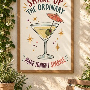 May include: A framed rectangular wall art print featuring a martini glass with an olive and a small red cocktail umbrella. The text reads SHAKE UP THE ORDINARY and MAKE TONIGHT SPARKLE in red and dark green, surrounded by yellow starburst accents.