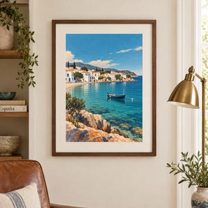 May include: A framed wall art print depicting a coastal Mediterranean scene with white buildings, a small blue boat floating on clear turquoise water, and rocky foreground cliffs under a bright blue sky with scattered white clouds.