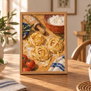 May include: A framed painting depicting three nests of fresh pasta on a wooden surface dusted with flour. The scene includes a wooden rolling pin, a bowl of flour, three red tomatoes, and a blue and white striped cloth in a warm, rustic style.