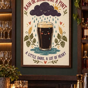 May include: A framed wall art print featuring a smiling dark beer glass under a rain cloud with the text RAIN OR SHINE, HAVE A PINT and A LITTLE DARK, A LOT OF HEART. The illustration includes wheat stalks, hops, and small red hearts on a cream background.