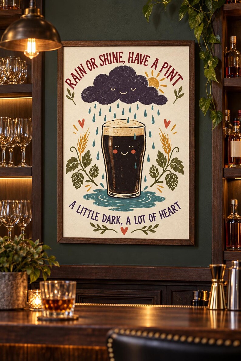 May include: A framed wall art print featuring a smiling dark beer glass under a rain cloud with the text RAIN OR SHINE, HAVE A PINT and A LITTLE DARK, A LOT OF HEART. The illustration includes wheat stalks, hops, and small red hearts on a cream background.