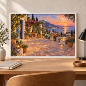 May include: A framed landscape print depicting a Mediterranean terrace at sunset. The scene features a tiled patio with potted lemon trees, pink bougainvillea, and lanterns. A person sits playing a guitar under a pergola overlooking a coastal town.