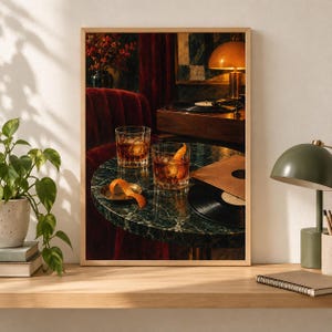 May include: A framed wall art print depicting a dark, moody interior scene with two crystal glasses filled with amber liquid and orange peels on a round green marble table. A black vinyl record, a record player, and a lamp are visible in the background.