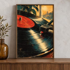 May include: A framed wall art print featuring a close-up of a black vinyl record on a turntable. The record has a bright red center label. The background depicts a stylized sunset scene with silhouettes of palm trees and buildings in warm tones.