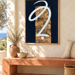 May include: A rectangular framed wall art piece featuring a dark navy blue background with a central vertical panel of textured gold leaf. A single, fluid, white brushstroke forms a continuous abstract loop and a small dot in the center.