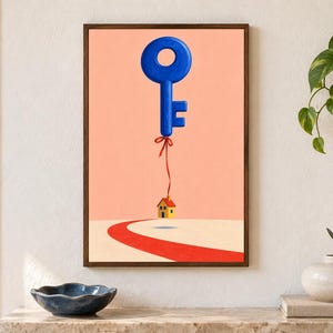 May include: A framed wall art print featuring a large blue key floating in a peach-colored sky, tethered by a thin red ribbon to a small yellow house with a red roof that hovers above a curved red path on a light beige ground.