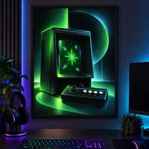 Puede incluir: Una impresi&oacute;n de arte mural enmarcada que presenta una consola de juegos Vectrex vintage con una pantalla verde brillante que muestra un gr&aacute;fico de estrella y formas geom&eacute;tricas, acompa&ntilde;ada de un controlador negro con cuatro botones y un joystick.