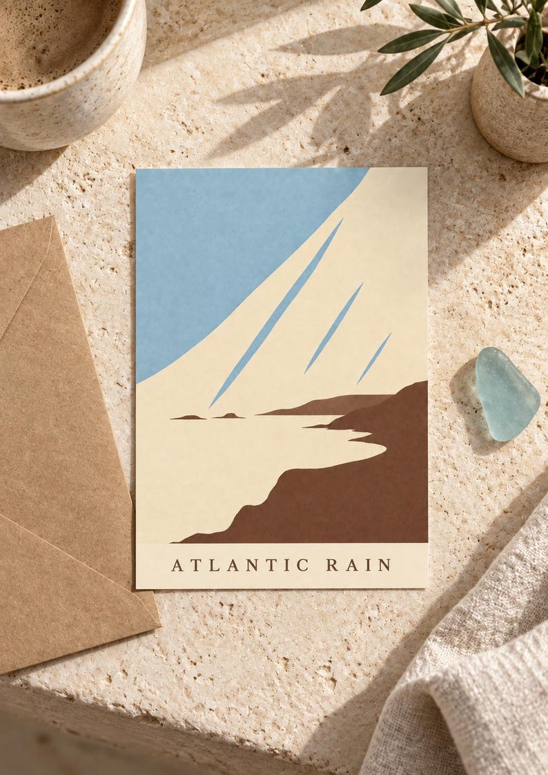 May include: A rectangular art print featuring a stylized coastal landscape with a dark brown shoreline, a light cream-colored sea, and a light blue sky with three diagonal streaks. The text ATLANTIC RAIN is printed in black at the bottom.
