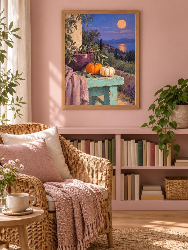 May include: A framed wall art print depicting a moonlit coastal landscape with a turquoise wooden table in the foreground. On the table sit a purple bowl with greenery, an orange pumpkin, a white pumpkin, and a draped lavender-colored fabric.