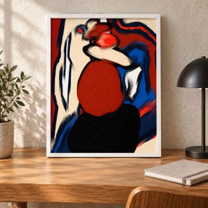 May include: A framed abstract art print featuring bold, expressive brushstrokes in primary colors. The composition includes a large central red circle, a solid black base, and sweeping accents of white, deep blue, and bright red against a cream background.