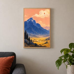 May include: A rectangular wall art print in a light wood frame depicting a landscape with a large blue mountain peak, a golden valley, and a small red kite flying in a soft peach-coloured sky with white clouds above the mountain summit.
