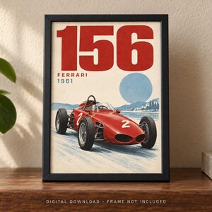 May include: A framed poster featuring a red 1961 Ferrari 156 race car with the number 2 on its side. The design includes the large red text 156, the word FERRARI, and the year 1961 in red, set against a light background with a blue circle and landscape.