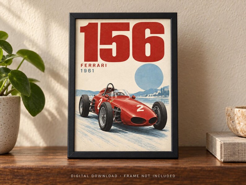 May include: A framed poster featuring a red 1961 Ferrari 156 race car with the number 2 on its side. The design includes the large red text 156, the word FERRARI, and the year 1961 in red, set against a light background with a blue circle and landscape.