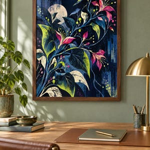 May include: A framed wall art print featuring a dark blue nocturnal scene with a large pale moon, vibrant pink flowers, and deep green foliage. The artwork displays a stylised botanical composition with sweeping branches and textured paint strokes.